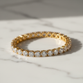 Lab-grown diamond tennis bracelet in yellow gold on white marble