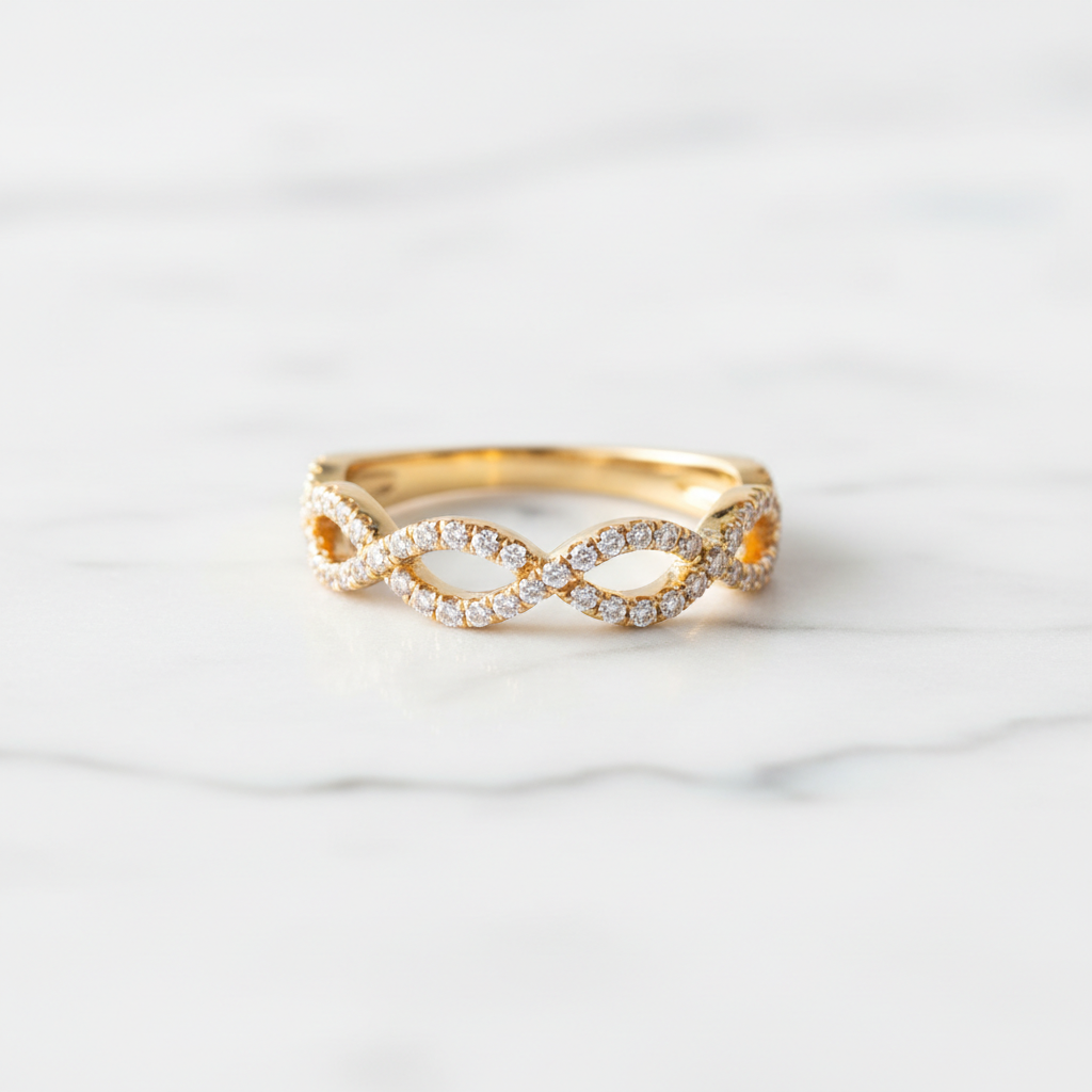 Lab-grown diamond infinity ring in yellow gold on white marble