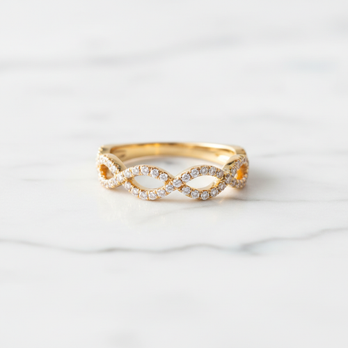Lab-grown diamond infinity ring in yellow gold on white marble
